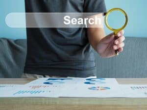 search,technology,search,engine,optimization.,man's,hand,holding,a,magnifying