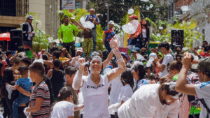 Joyful people enjoying foam party outdoors.