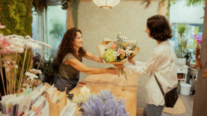 Florist giving bouquet to customer in shop