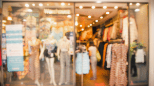Blurred clothing store interior view with mannequins.