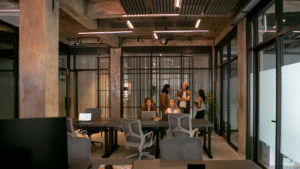 People working and discussing in modern office space.
