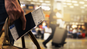 Traveler holding passport and boarding pass at airport